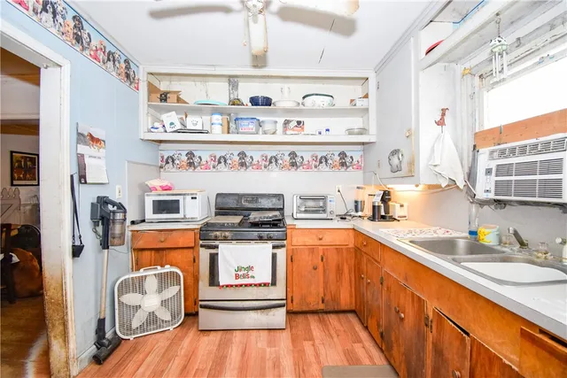 a kitchen with stainless steel appliances granite countertop a sink and wooden floors