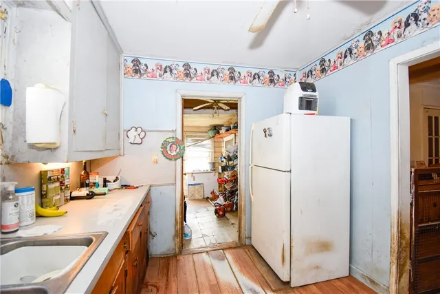 a white refrigerator freezer sitting inside of a kitchen