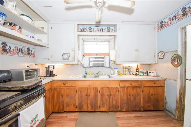a kitchen with a stove a sink and a cabinets