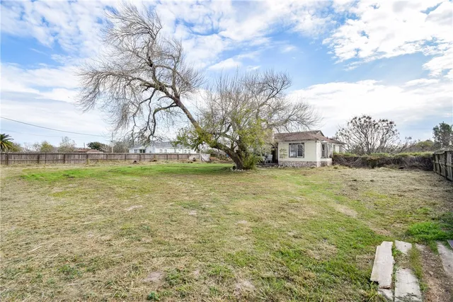 a view of open space with garden and trees
