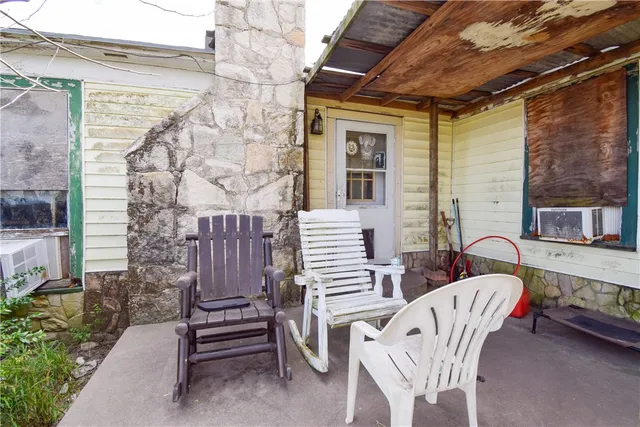 a view of two chairs in the patio