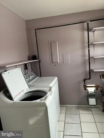 a view of kitchen with stainless steel appliances a refrigerator and a microwave