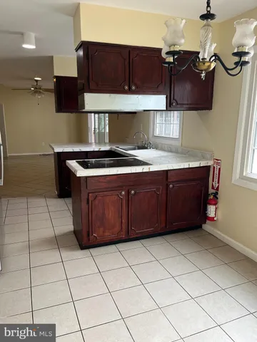 a kitchen with a cabinets and a stove top oven