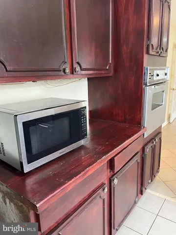 a kitchen with stainless steel appliances wooden cabinets and a stove top oven