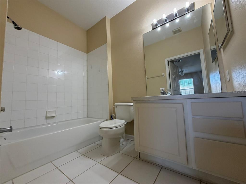13560 Turtle Marsh Loop, Unit 332 Orlando, FL 32837 - Photo 11 of 16 a bathroom with a toilet a sink and bathtub