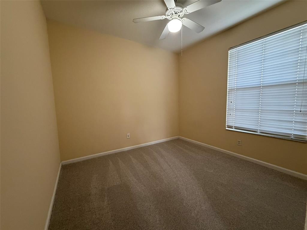 13560 Turtle Marsh Loop, Unit 332 Orlando, FL 32837 - Photo 12 of 16 an empty room with a window and a fan