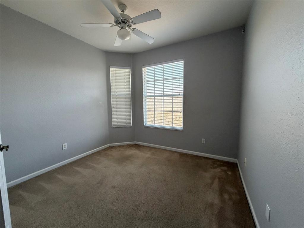 13560 Turtle Marsh Loop, Unit 332 Orlando, FL 32837 - Photo 13 of 16 an empty room with a window and a fan