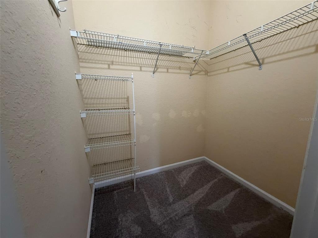 13560 Turtle Marsh Loop, Unit 332 Orlando, FL 32837 - Photo 15 of 16 a view of walk in closet with empty racks