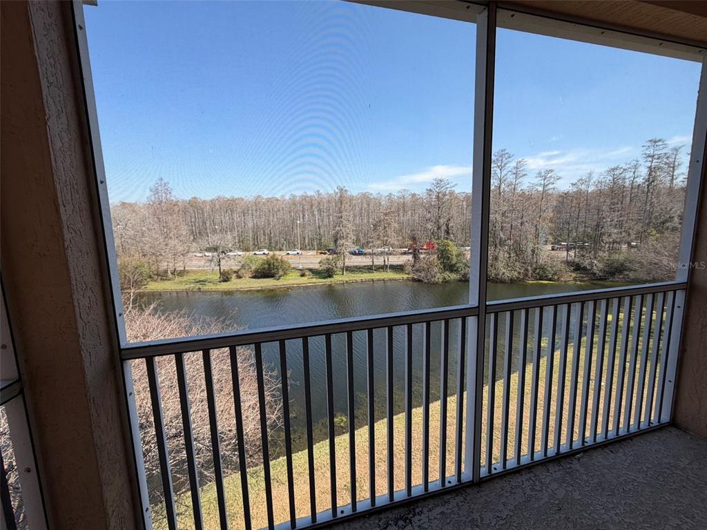 13560 Turtle Marsh Loop, Unit 332 Orlando, FL 32837 - Photo 16 of 16 a view of a balcony with wooden floor & fence