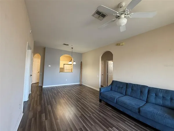 a living room with furniture and a mirror