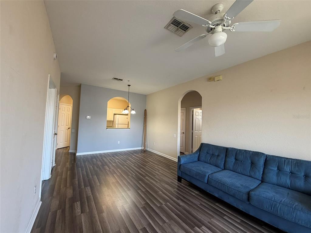 13560 Turtle Marsh Loop, Unit 332 Orlando, FL 32837 - Photo 16 of 16 a living room with furniture and a mirror