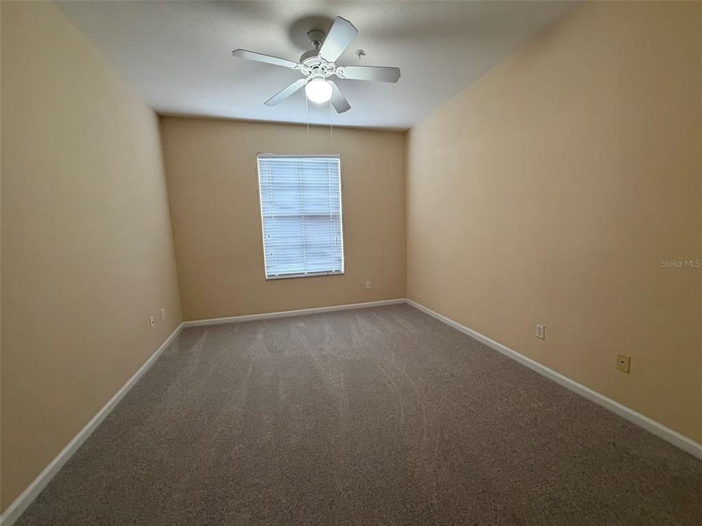 13560 Turtle Marsh Loop, Unit 332 Orlando, FL 32837 - Photo 3 of 16 an empty room with a window and a fan