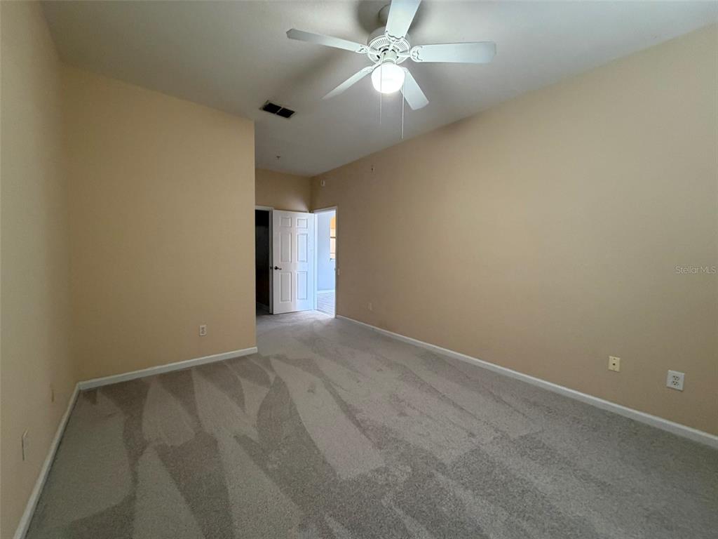 13560 Turtle Marsh Loop, Unit 332 Orlando, FL 32837 - Photo 4 of 16 an empty room with a ceiling fan and a window