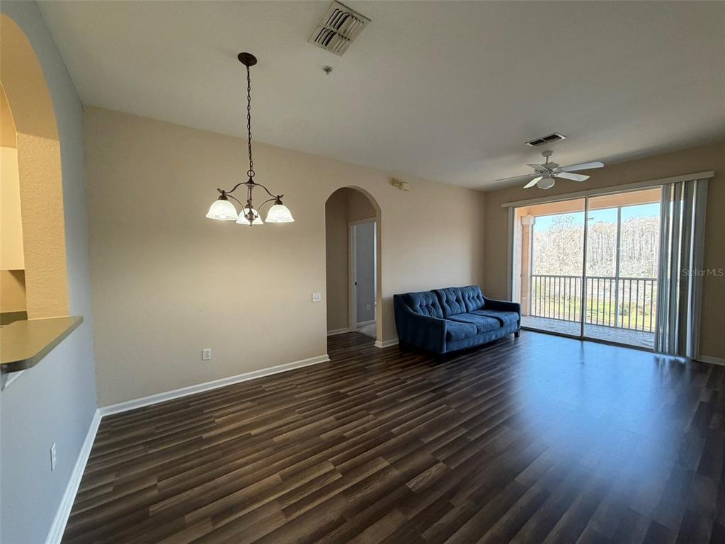 13560 Turtle Marsh Loop, Unit 332 Orlando, FL 32837 - Photo 6 of 16 a view of a room with wooden floor chandelier and windows