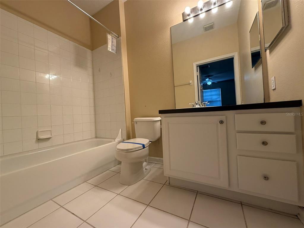 13560 Turtle Marsh Loop, Unit 332 Orlando, FL 32837 - Photo 9 of 16 a bathroom with a toilet sink and tub