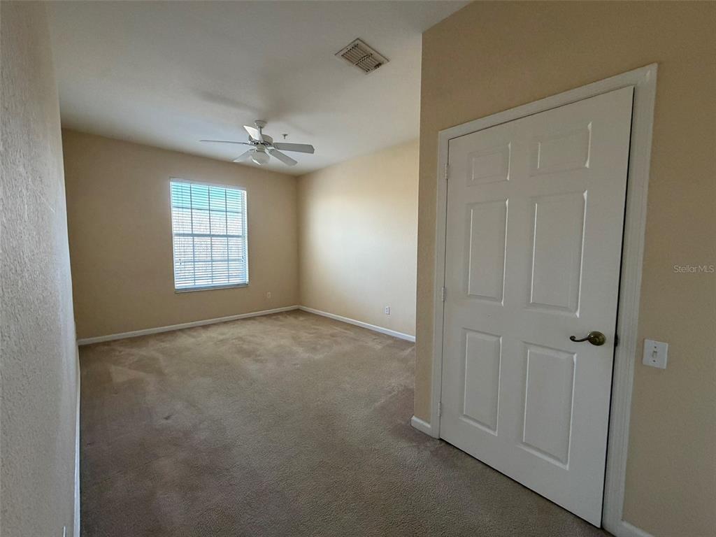 13560 Turtle Marsh Loop, Unit 332 Orlando, FL 32837 - Photo 9 of 16 an empty room with windows and cabinet