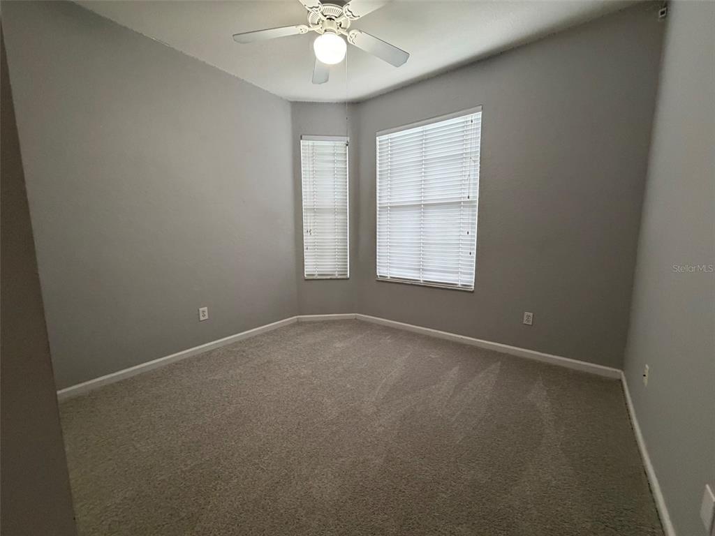 13560 Turtle Marsh Loop, Unit 332 Orlando, FL 32837 - Photo 10 of 16 an empty room with windows and fan