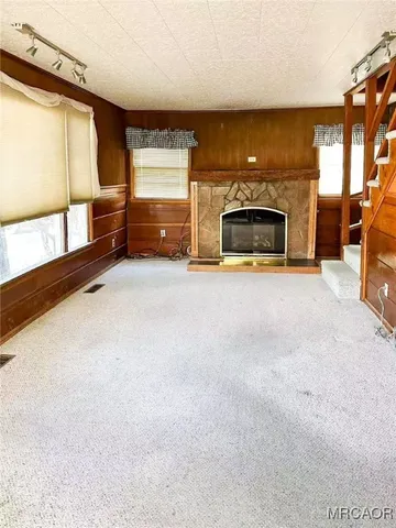 a view of empty room with a fireplace