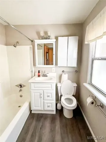 a bathroom with a double vanity sink toilet mirror and bathtub