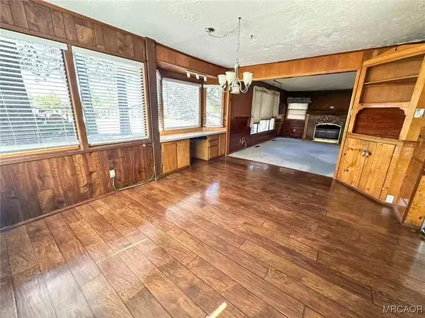 a view of a livingroom with furniture window and wooden floor