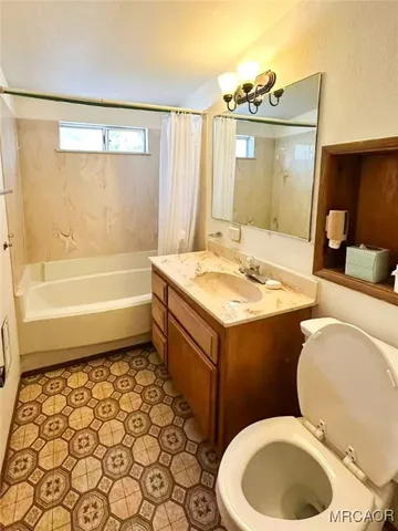 a bathroom with a sink a toilet and bathtub
