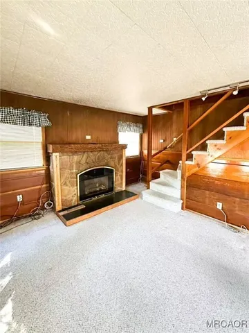 an empty room with furniture and a fireplace