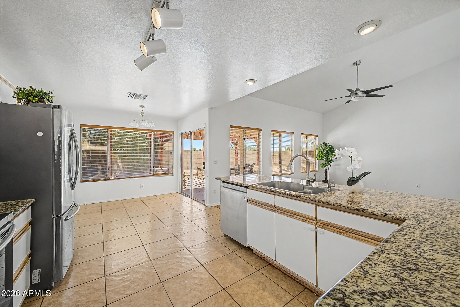 2762 North Ricardo Mesa, AZ 85215 - Photo 20 of 38 a large kitchen with kitchen island a large counter space a sink appliances and cabinets