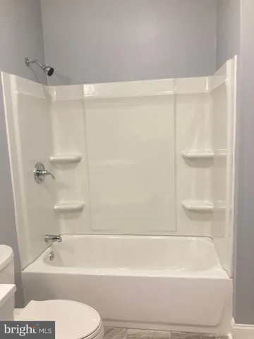 a bathroom with a bathtub and a toilet
