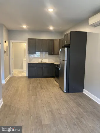 a large kitchen with a refrigerator and a sink