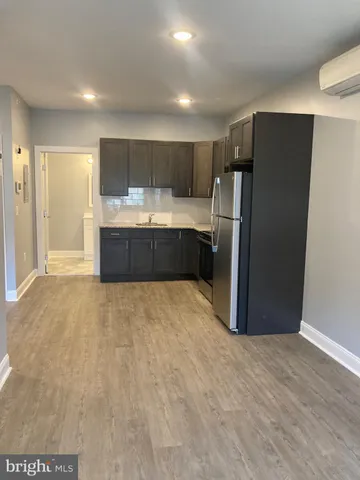 a large kitchen with a refrigerator and a sink