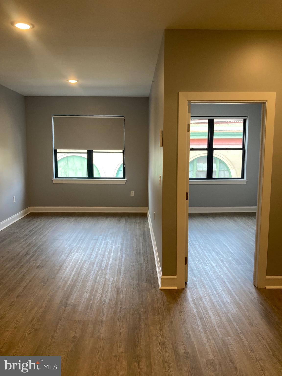 4663 Paul Street, Unit 4 Philadelphia, PA 19124 - Photo 9 of 10 an empty room with wooden floor and windows