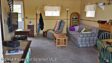 490 State Rte 2005 Springville, PA 18844 - Photo 8 of 24 a living room with furniture a fireplace and a window