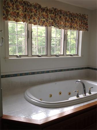 222 Charnock Hill Road Rutland, MA 01543 - Photo 12 of 24 a bathroom with a tub and a window