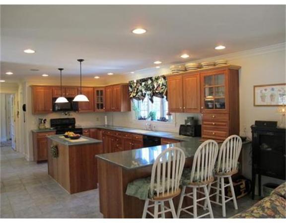 222 Charnock Hill Road Rutland, MA 01543 - Photo 3 of 24 a kitchen with stainless steel appliances granite countertop a stove a refrigerator a oven a sink with a dining table and chairs