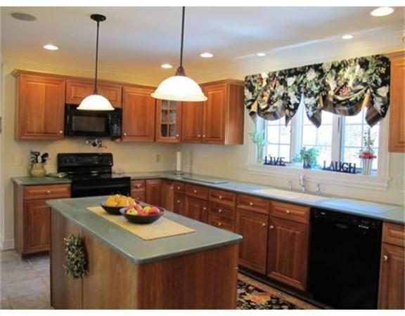 222 Charnock Hill Road Rutland, MA 01543 - Photo 5 of 24 a kitchen with a sink a microwave a stove and a window