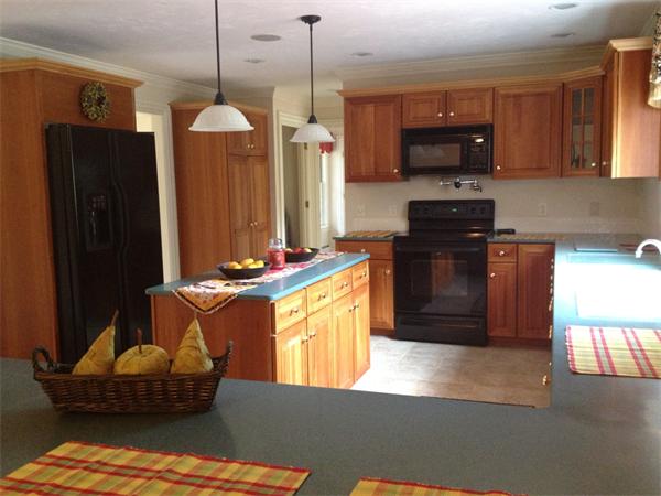 222 Charnock Hill Road Rutland, MA 01543 - Photo 6 of 24 a kitchen with stainless steel appliances granite countertop a refrigerator a stove and a sink with wooden floor
