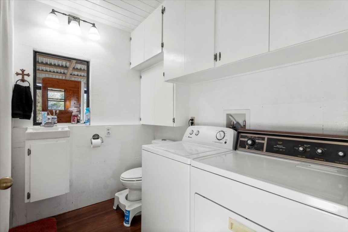 4339 Pettytown Road Dale, TX 78616 - Photo 17 of 33 Laundry area and bathroom with dark wood finished floors, washer and clothes dryer, and wooden ceiling