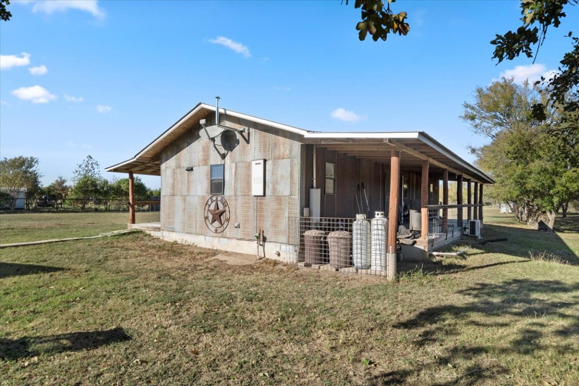 4339 Pettytown Road Dale, TX 78616 - Photo 25 of 33 View of property exterior featuring a lawn and a large porch