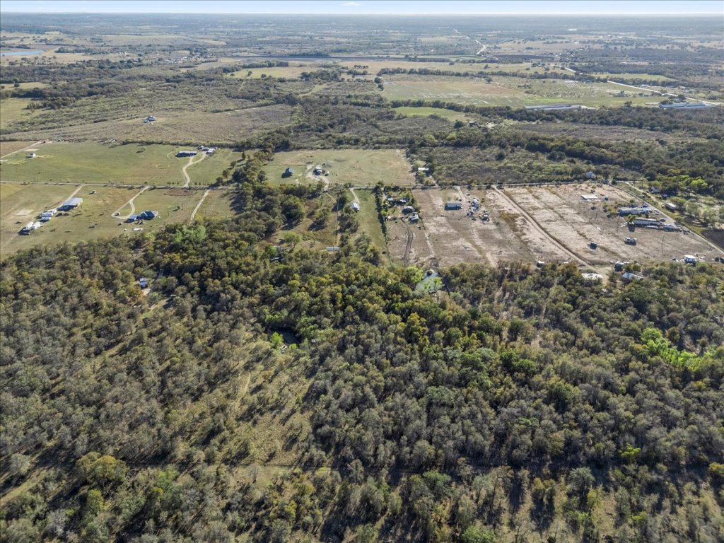 4339 Pettytown Road Dale, TX 78616 - Photo 31 of 33 Aerial view of property and surrounding area with a heavily wooded area