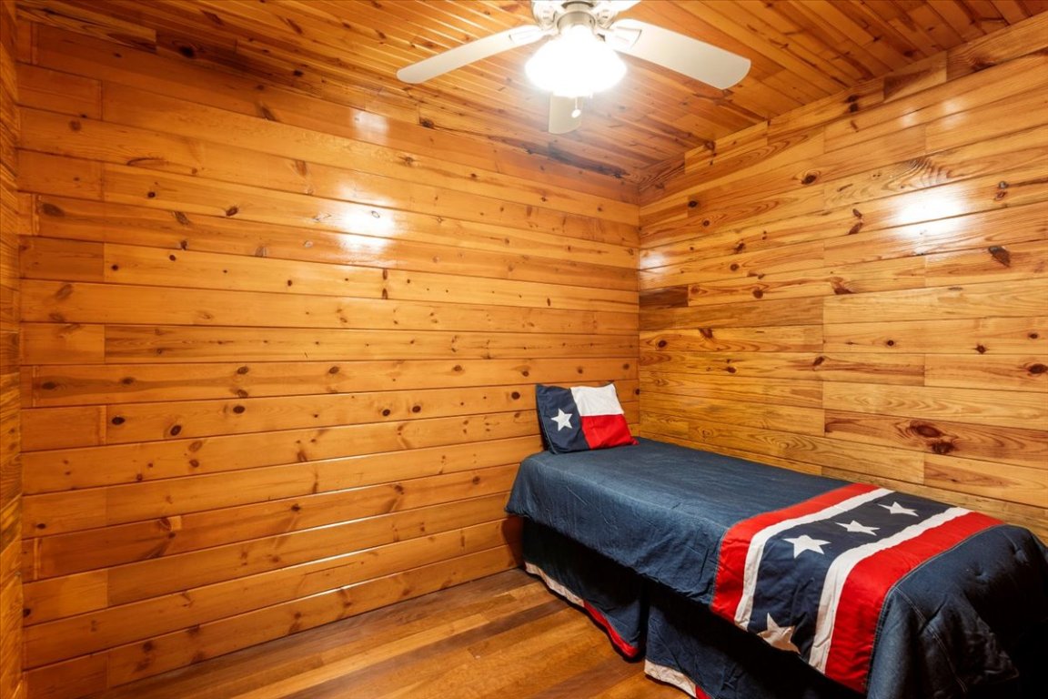 4339 Pettytown Road Dale, TX 78616 - Photo 10 of 33 Bedroom/office wood finished floors, wooden ceiling, a ceiling fan, and wood walls