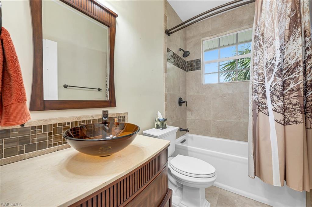 558 Corbel Drive Naples, FL 34110 - Photo 16 of 22 a bathroom with a sink toilet and shower