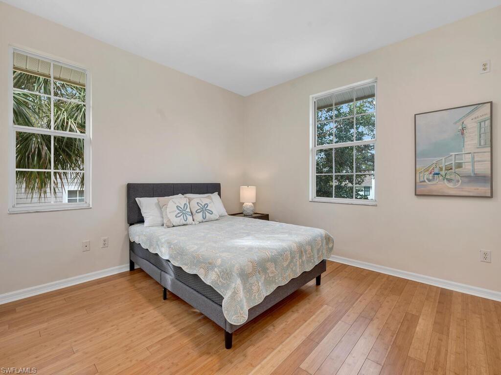 558 Corbel Drive Naples, FL 34110 - Photo 18 of 22 a bed sitting in a bedroom next to a window