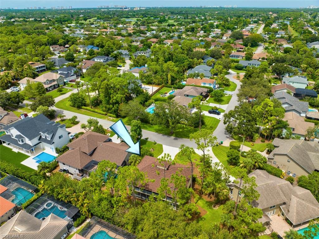 558 Corbel Drive Naples, FL 34110 - Photo 3 of 22 an aerial view of residential houses with outdoor space and trees
