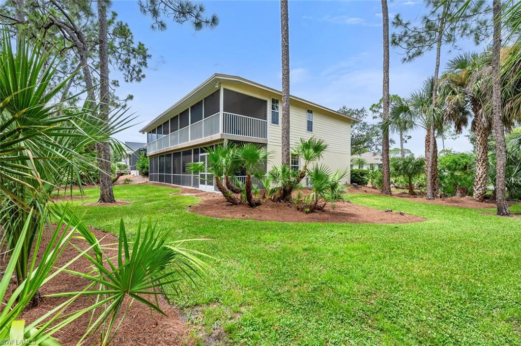 558 Corbel Drive Naples, FL 34110 - Photo 4 of 22 a view of a house with a yard and sitting area