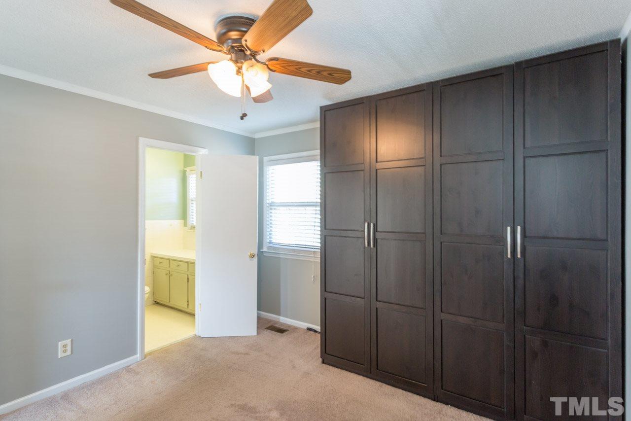 5405 Cheek Road Durham, NC 27704 - Photo 13 of 24 a view of an empty room with closet and a chandelier fan