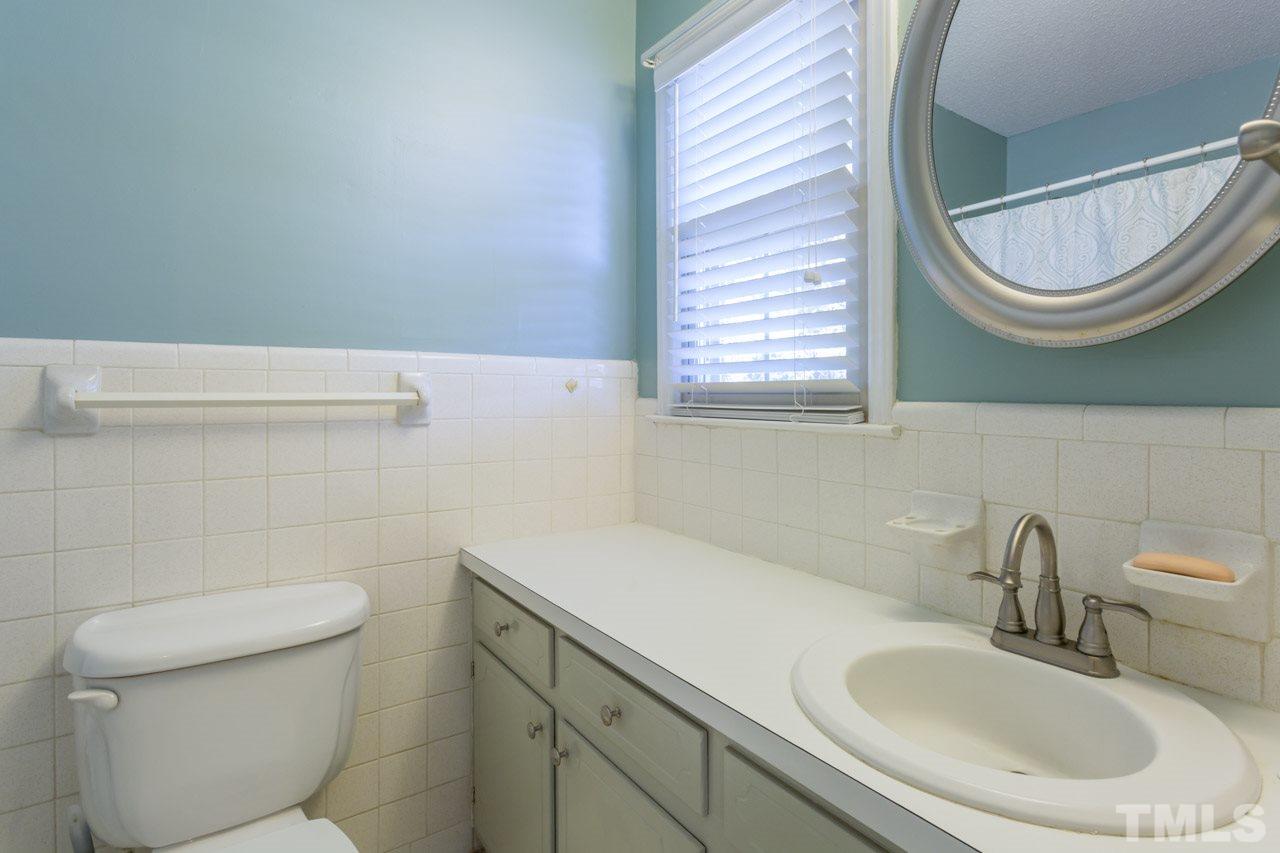 5405 Cheek Road Durham, NC 27704 - Photo 14 of 24 a bathroom with a toilet and a sink