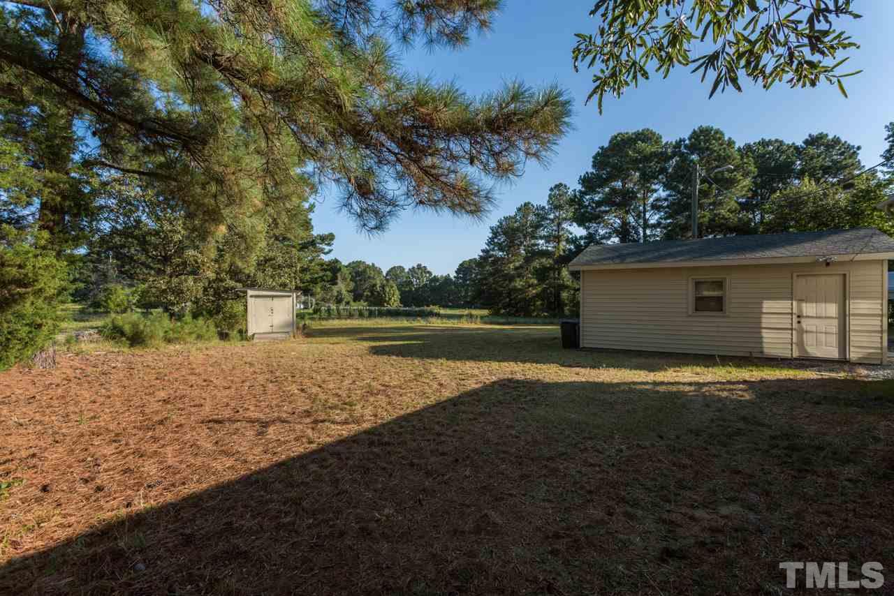 5405 Cheek Road Durham, NC 27704 - Photo 22 of 24 a view of outdoor space with yard and trees