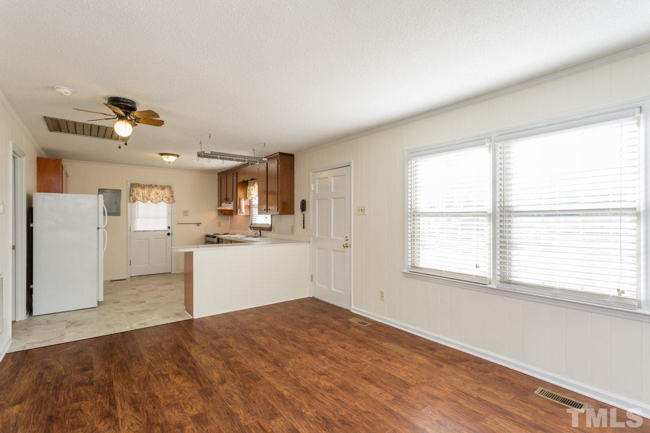 5405 Cheek Road Durham, NC 27704 - Photo 6 of 24 a view of a kitchen with furniture and wooden floor