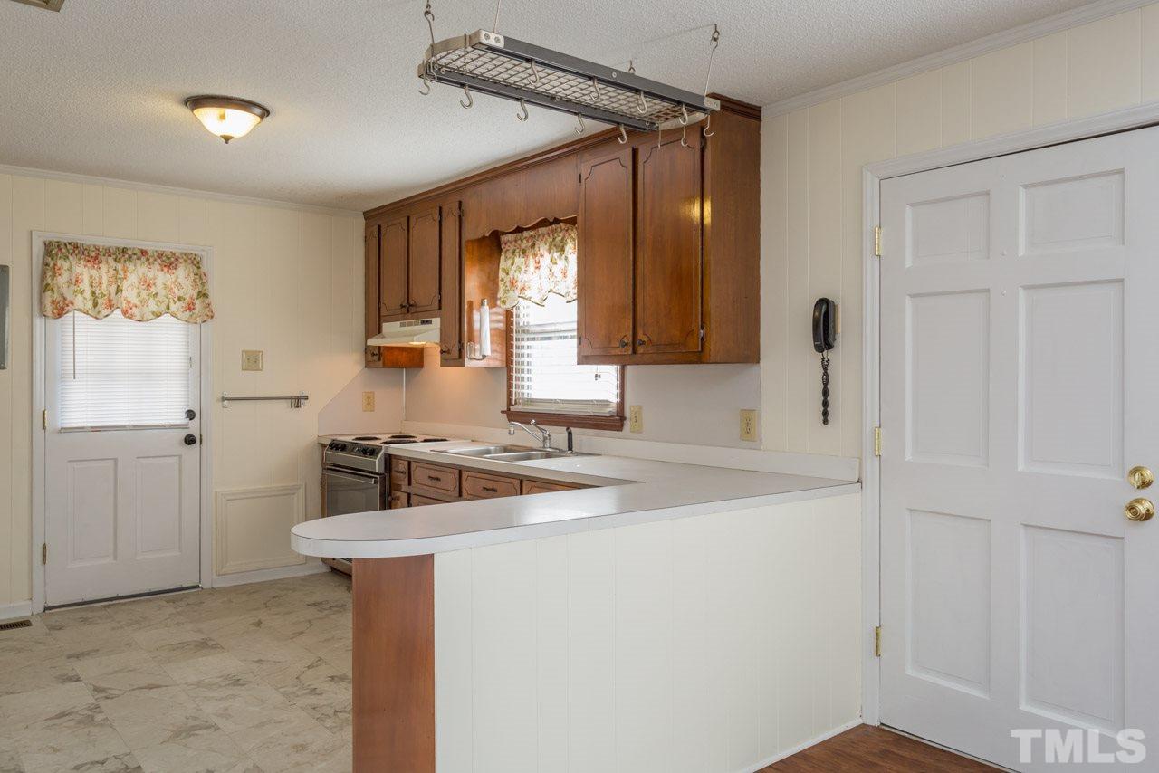 5405 Cheek Road Durham, NC 27704 - Photo 8 of 24 a bathroom with a sink a vanity and a mirror
