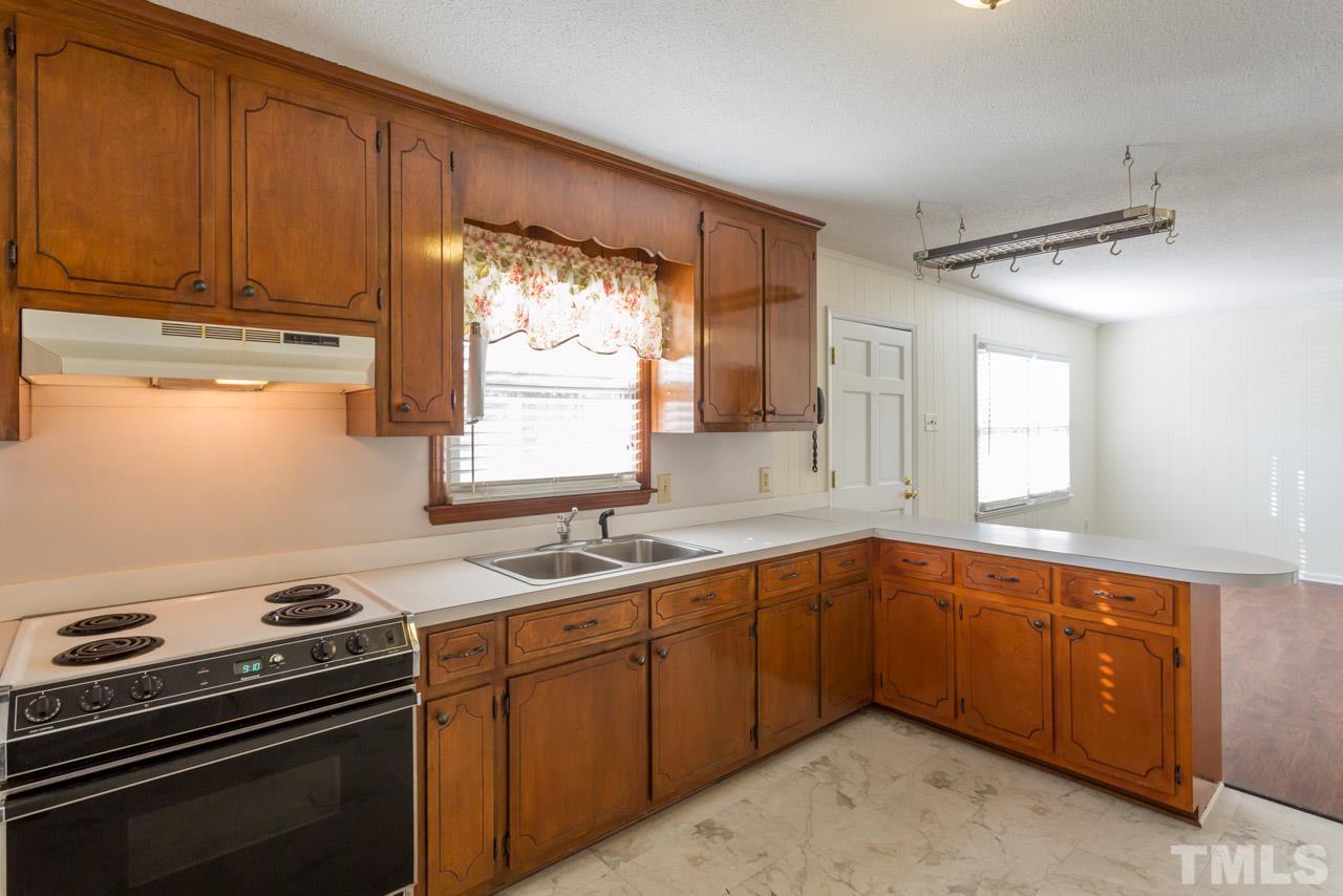 5405 Cheek Road Durham, NC 27704 - Photo 10 of 24 a kitchen with a sink stove and cabinets